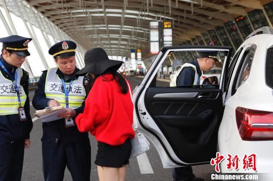 上海市交通委员会执法总队三支队的执法人员正在浦东国际机场T2航站楼出发层对牵涉非法营运车辆乘客进行事实取证。　殷立勤　摄