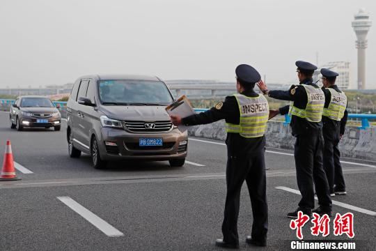 上海市交通委员会执法总队三支队的执法人员正在浦东国际机场T2航站楼出发层对牵涉非法营运车辆进行检查。　殷立勤　摄