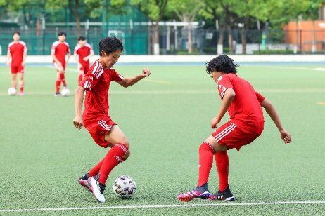 A couple of football players compete over a football ball

Description automatically generated with low confidence